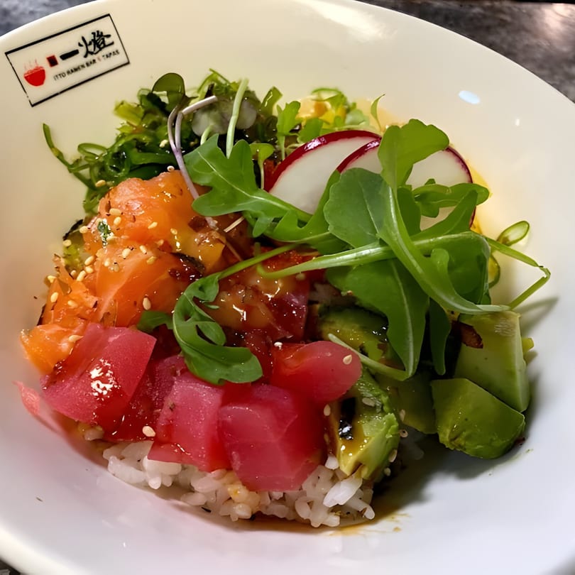 Itto Ramen Bar Tapas poke bowl with salmon, tuna, avocado, seaweed, radish, and greens over rice.